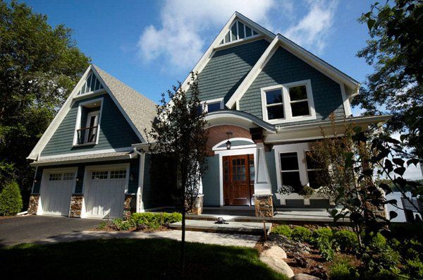 A large house with a blue roof and white trim