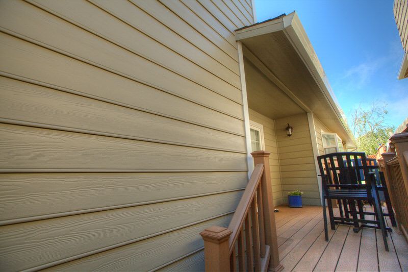 A house with a deck and a table and chairs on it.