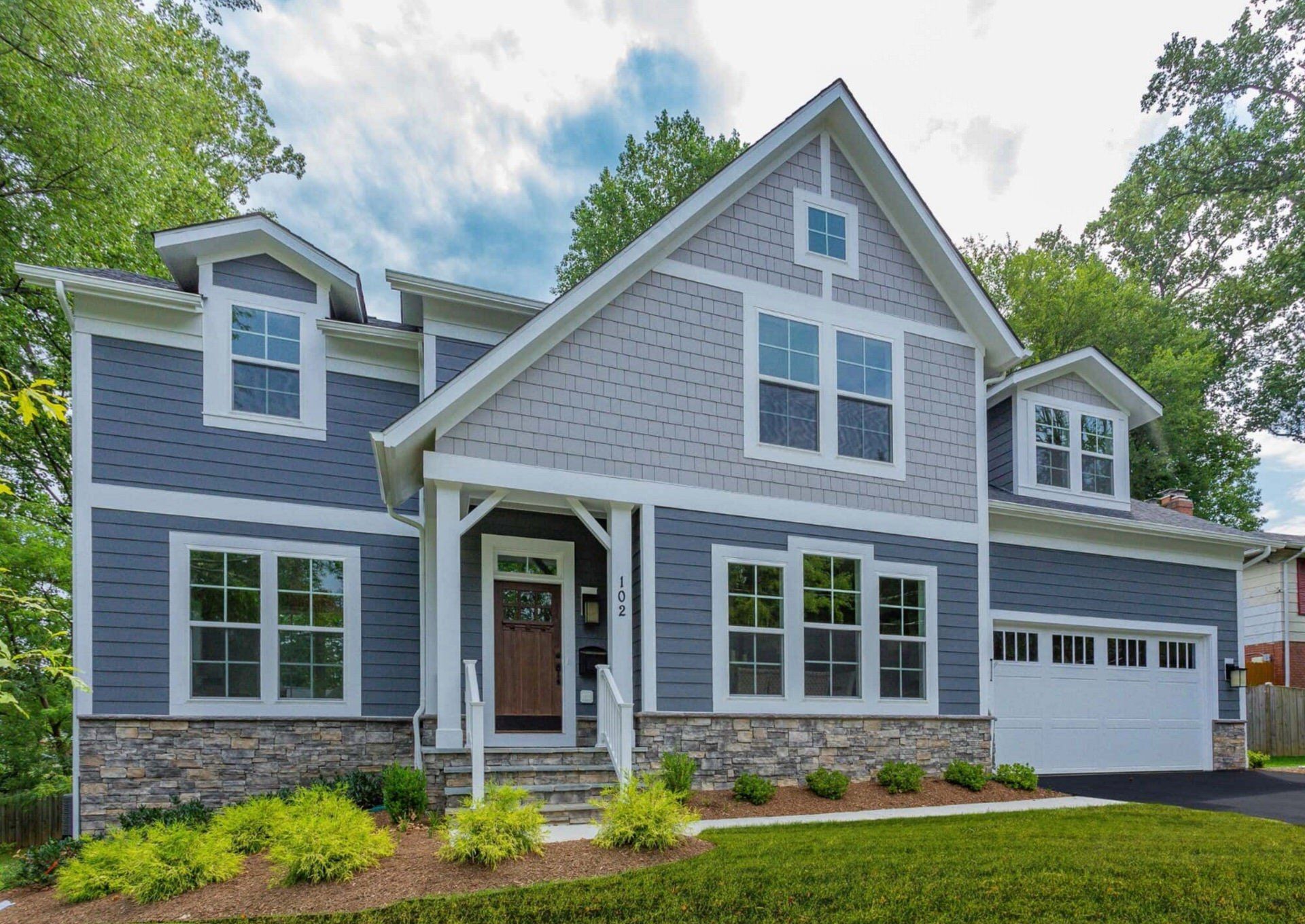 A large house with a lot of windows and a garage