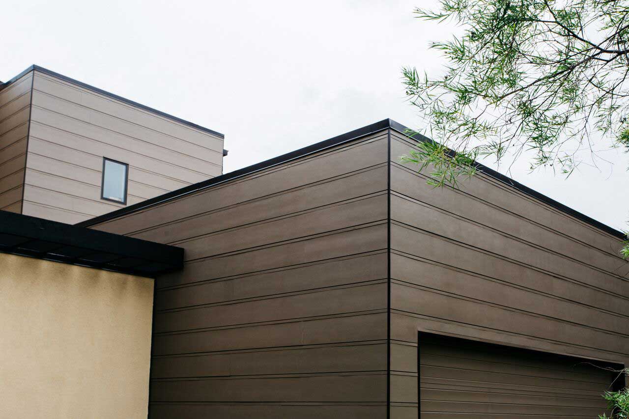 Close up of the fiber cement siding installed on a modern home.