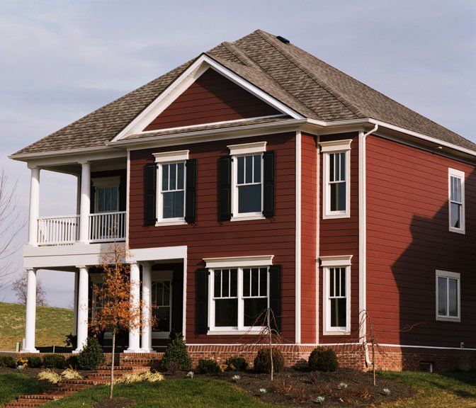 A large red house with white trim and black shutters