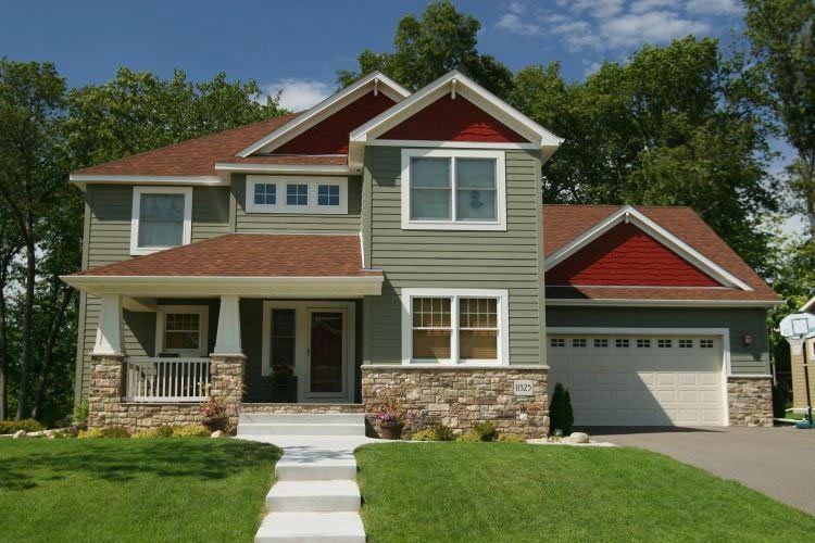 Traditional Texas home in green James Hardie fiber cement siding with traditional red shingles.