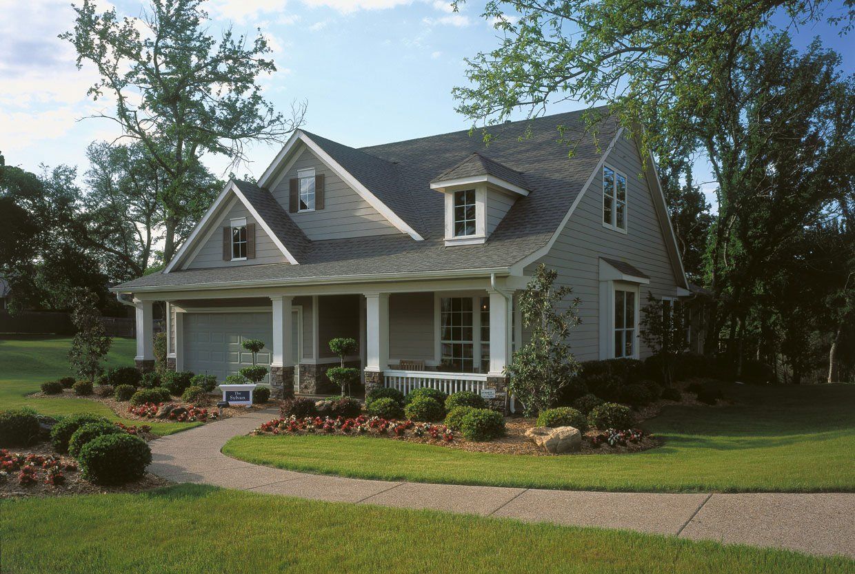 A house with a porch and a walkway leading to it