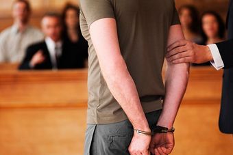 Handcuffed Man Standing in Courtroom — Tuscaloosa, AL — Wayne L Williams & Associates LLC