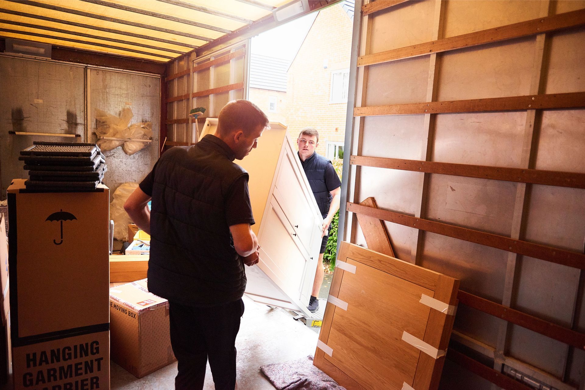 Boston furniture removal service hauling old dresser and chairs from residence