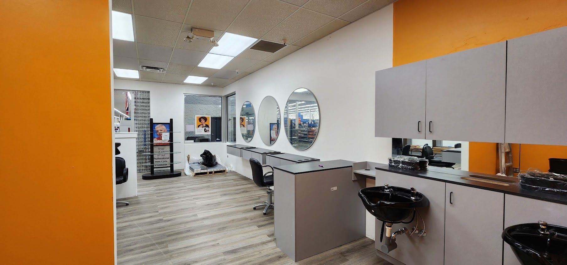 A hair salon with a lot of mirrors and sinks.