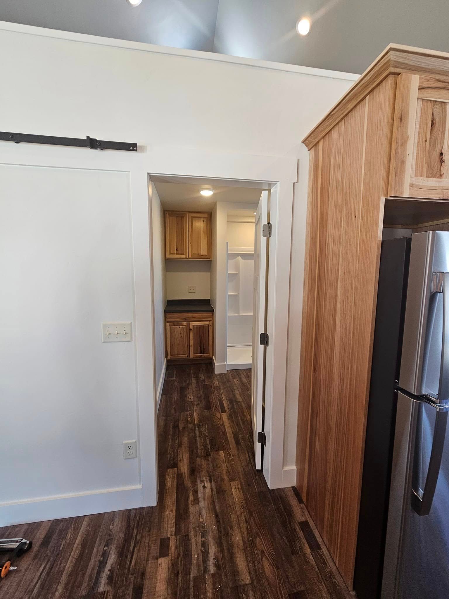 A kitchen with stainless steel appliances and wooden cabinets.