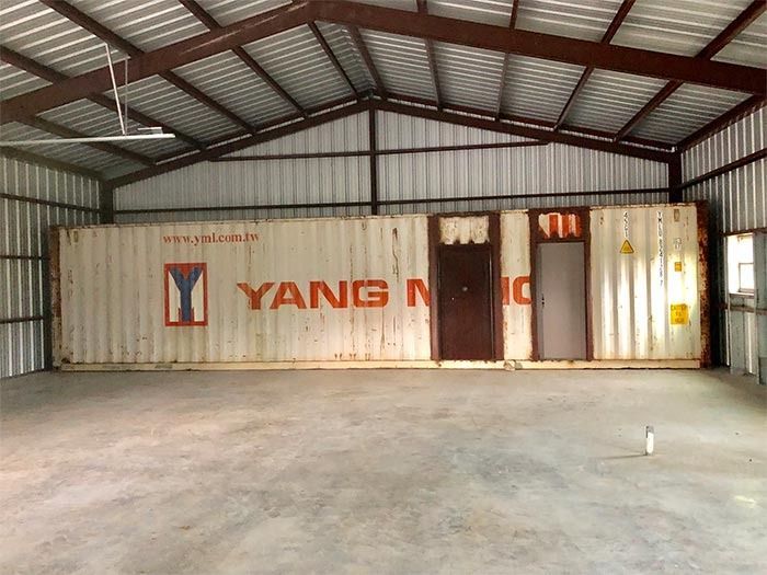 A large white shipping container marked 