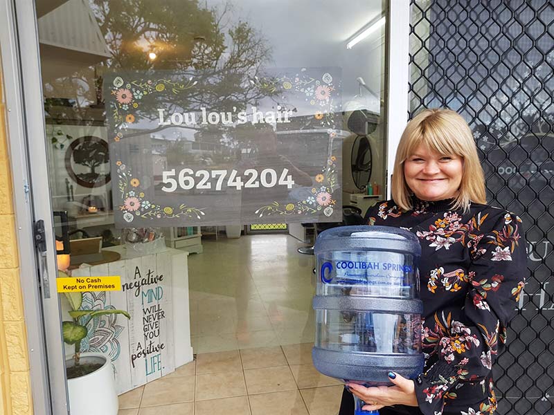 Client Woman Holding 15L Bottle — Bottled Water in Canungra, QLD