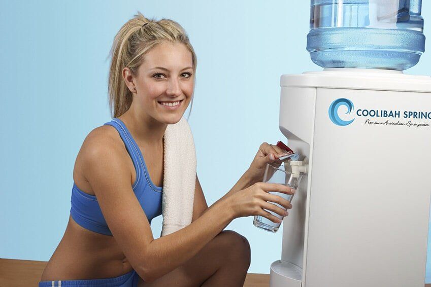 Woman Getting Water from Watercooler — Bottled Water in Canungra, QLD