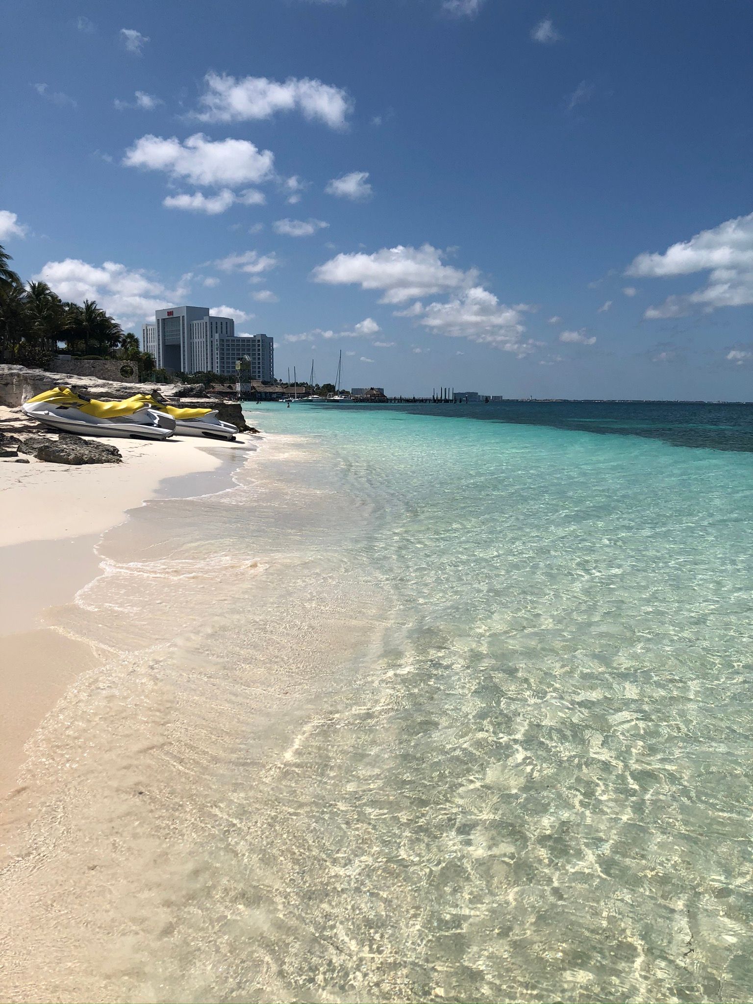 Cancun  beach with a lot of buildings in the background