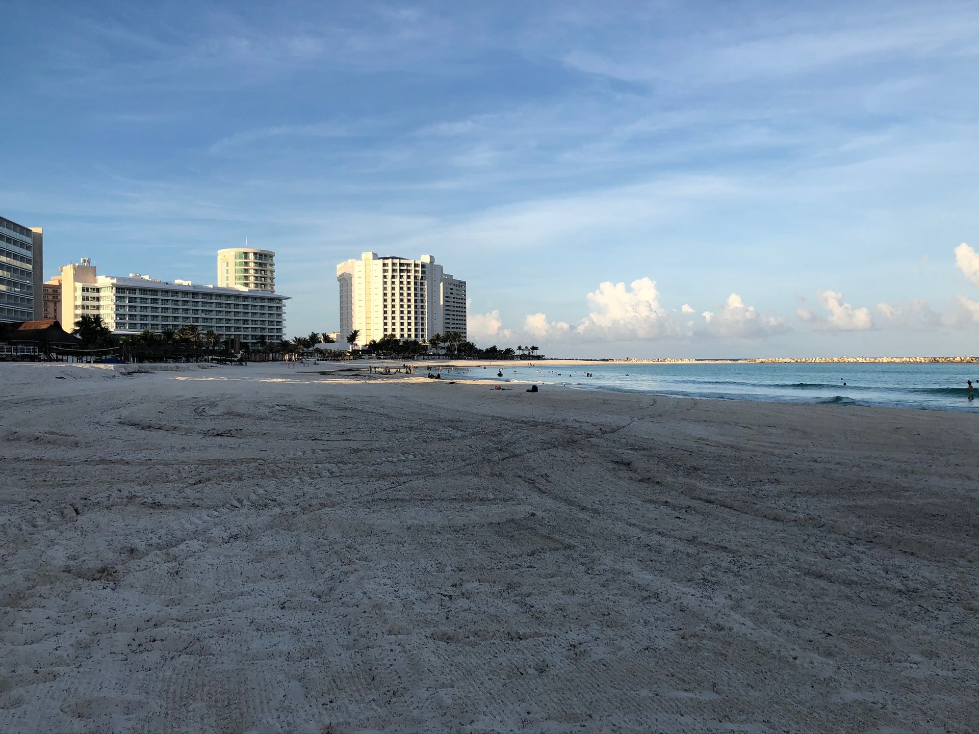 Cancun  beach with buildings in the background and a blue sky