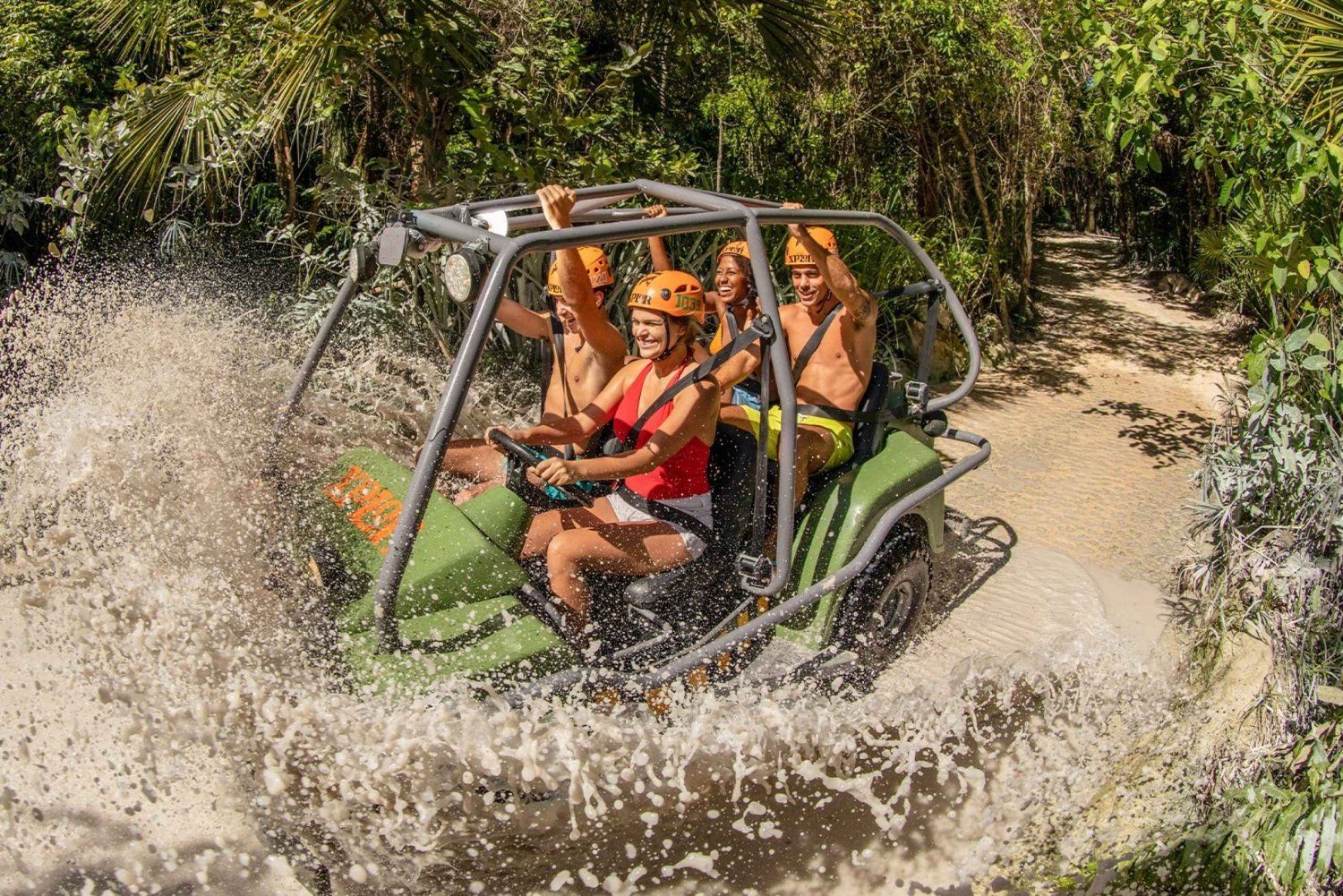 A group of people are riding a dune buggy through a river.