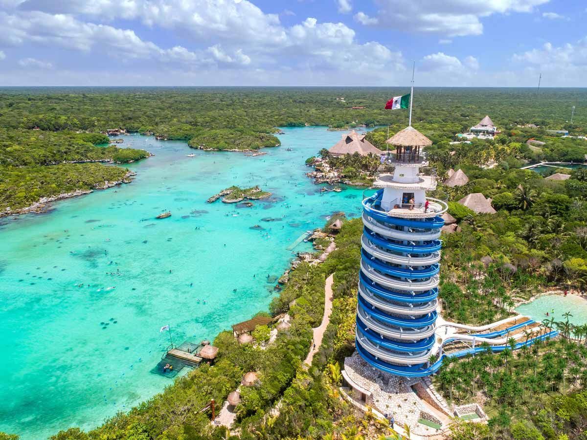 An aerial view of a water park with a tower in the middle of the water in Cancun