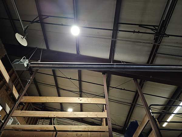 A light is hanging from the ceiling of a building.