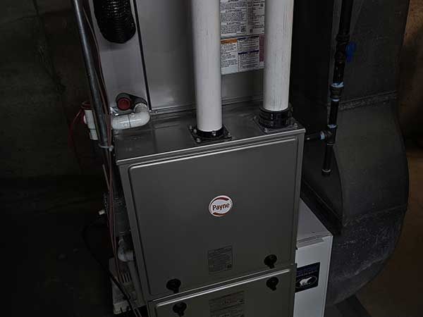 A close up of a heating and cooling system in a basement.