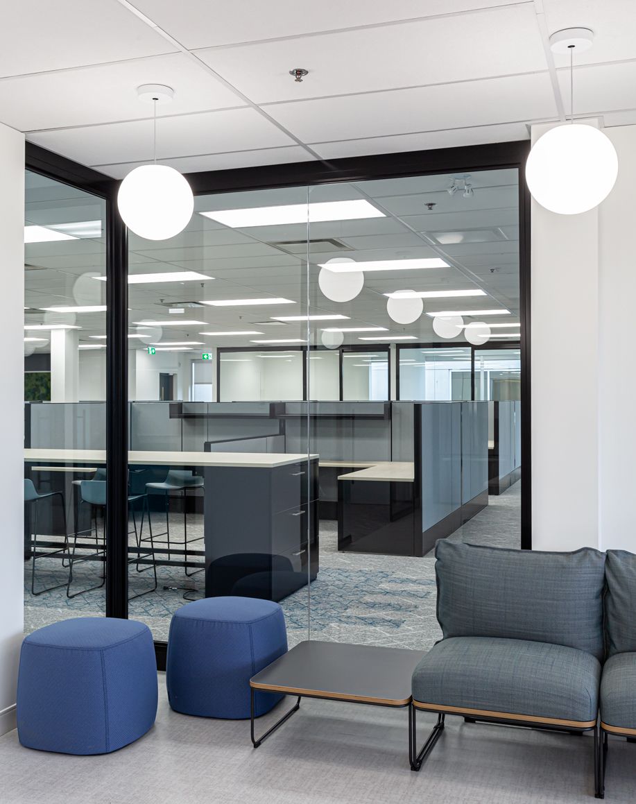 A room with a couch and ottomans in it