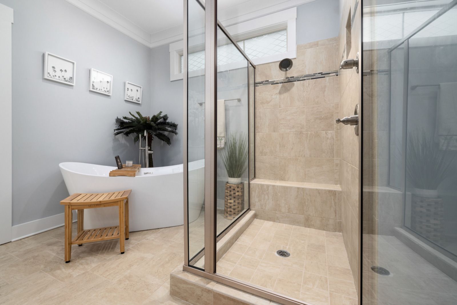 A bathroom with a bathtub and a walk in shower.