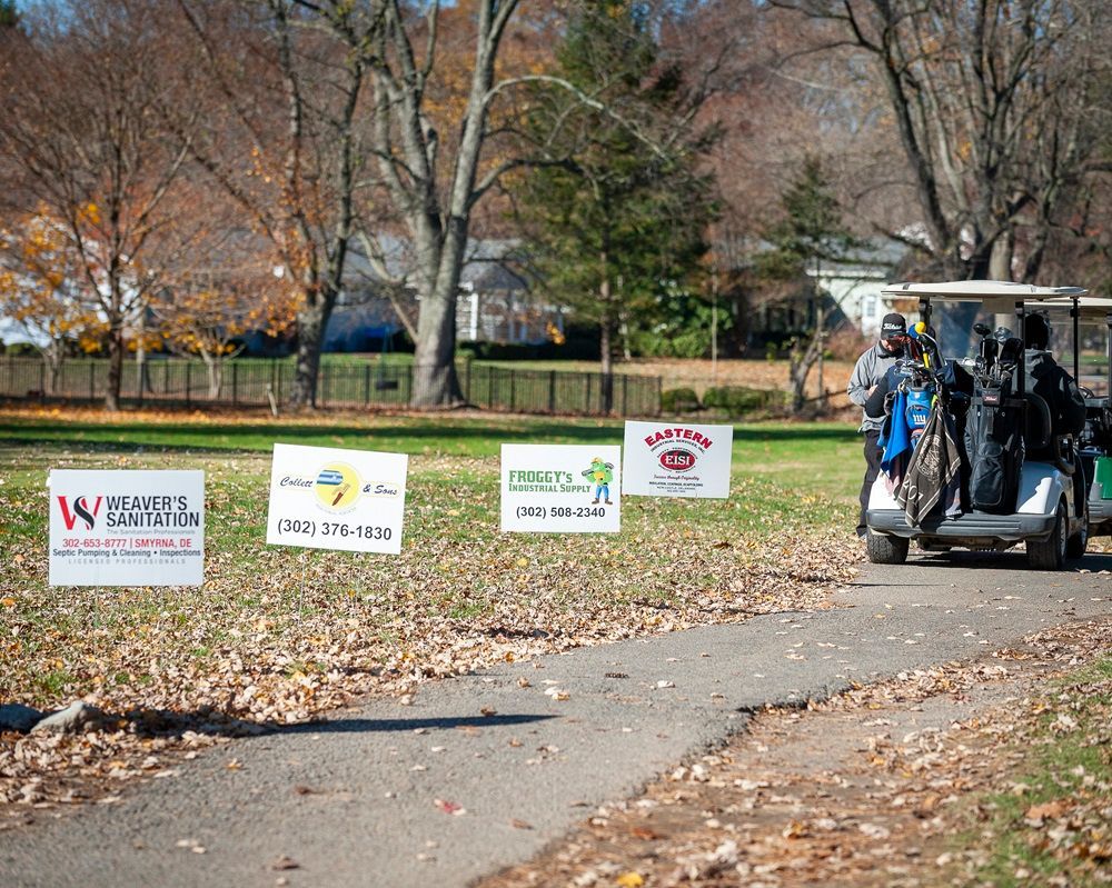 A golf cart is driving down a path in a park.
