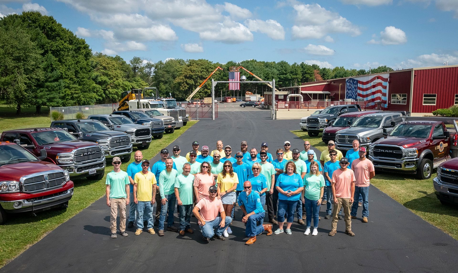 A red tow truck is parked on a lush green field.