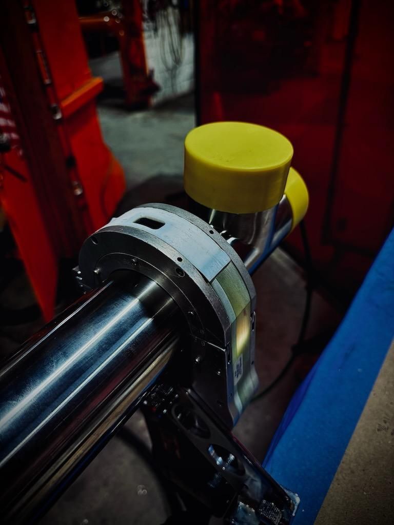 A metal pipe with a yellow cap on top of it