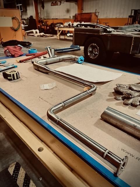 A piece of metal is sitting on top of a wooden table