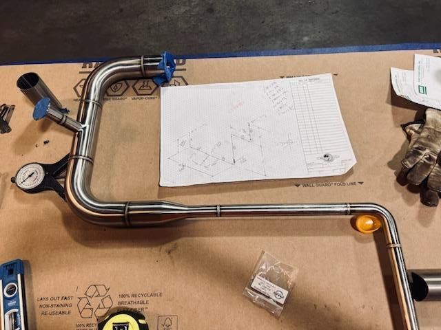 A drawing of a pipe is on a piece of paper