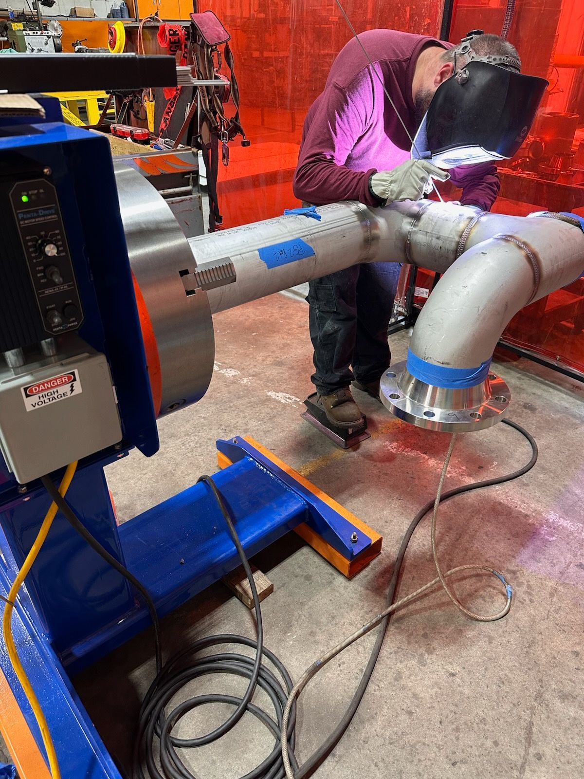 Two men standing on a platform that says jlg on it