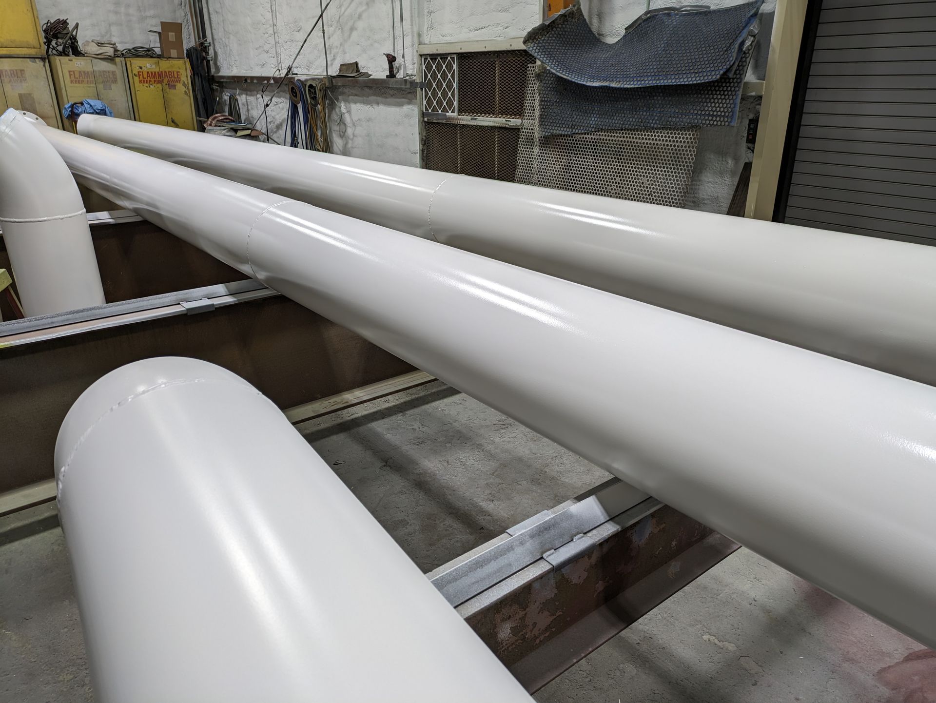 A bunch of white pipes are sitting on top of each other on a table.