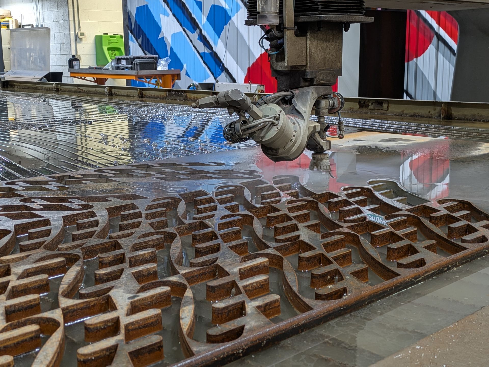 A machine is cutting a piece of metal with water.