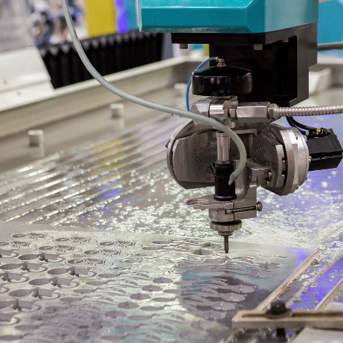 A machine is cutting a piece of metal with water.