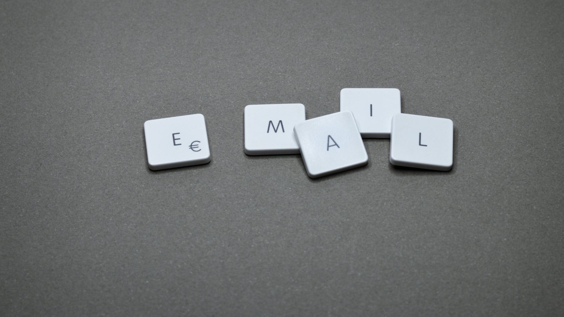 List Management Email Marketing. The letters e , m , a , and l are stacked on top of each other on a table.