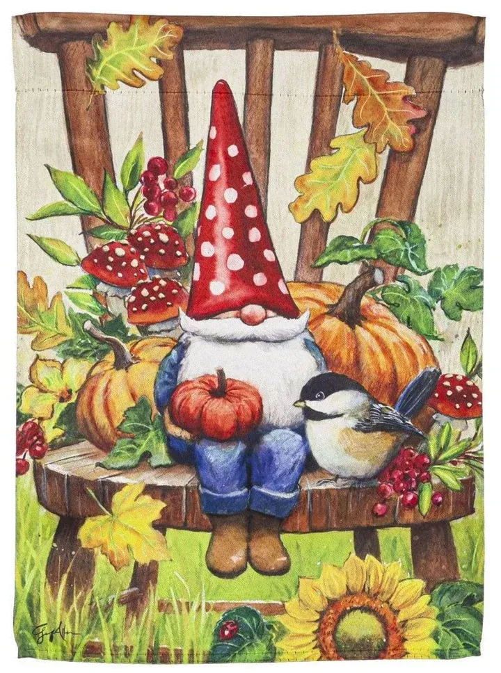 A gnome is sitting on a chair holding a pumpkin and a bird.