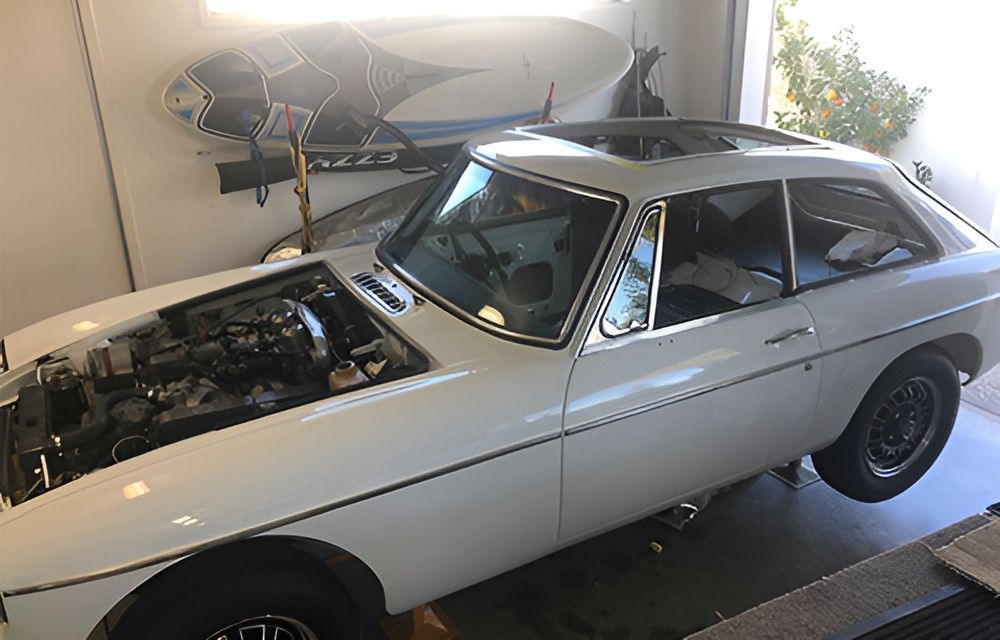 A White Car With the Hood Up is Parked in a Garage — Morayfield Autoglass in Caboolture South, QLD