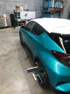 A Blue and White Car is Sitting in a Garage — Morayfield Autoglass in Caboolture South, QLD