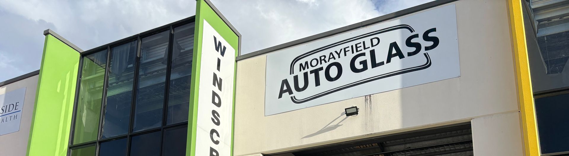 Exterior of Morayfield Auto Glass workshop with large signage on a commercial building