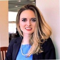 A man in a suit and tie is standing in front of a dictionary page.