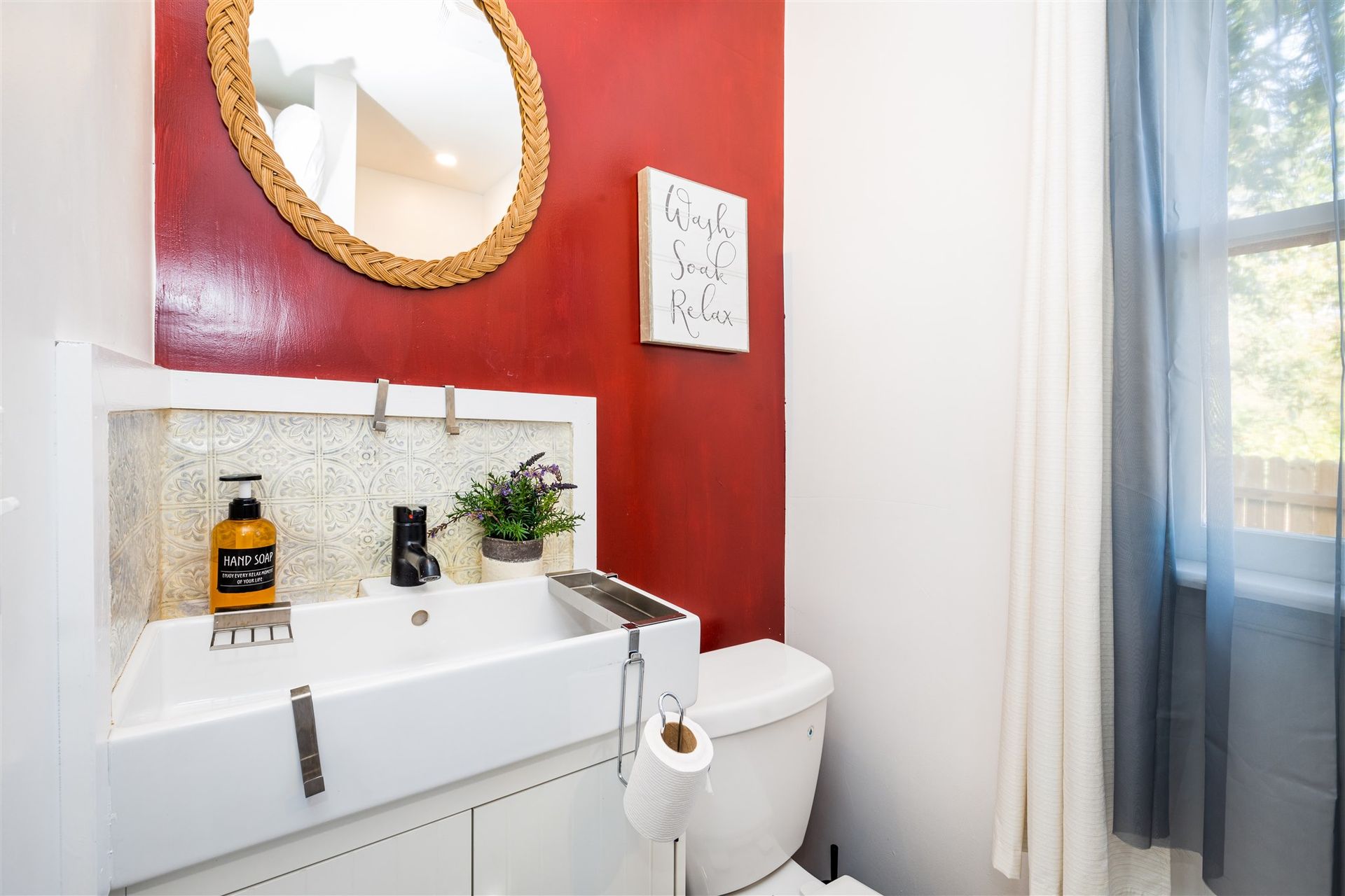 a bathroom with a sink , toilet and mirror .