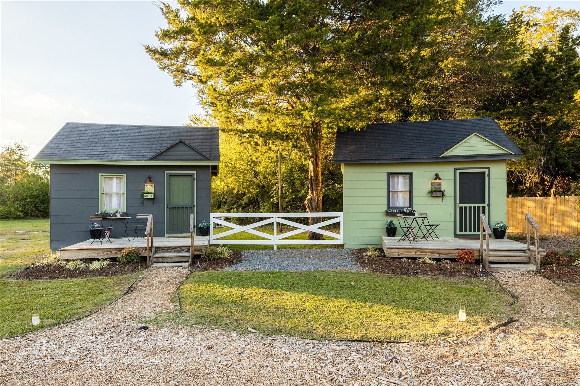 two small houses are sitting next to each other in a field .