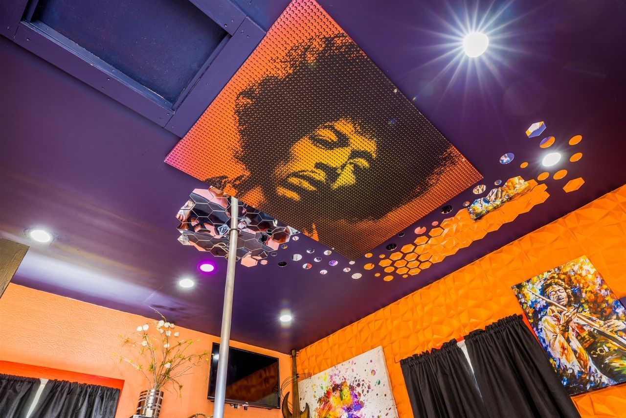 a room with a painting of jesus on the ceiling