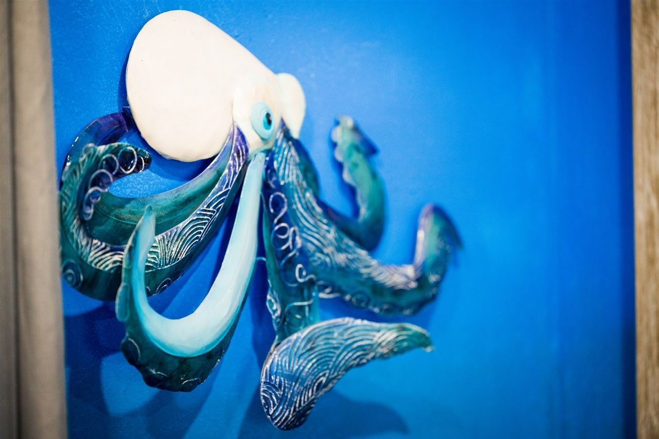 a painting of an octopus on a blue background .
