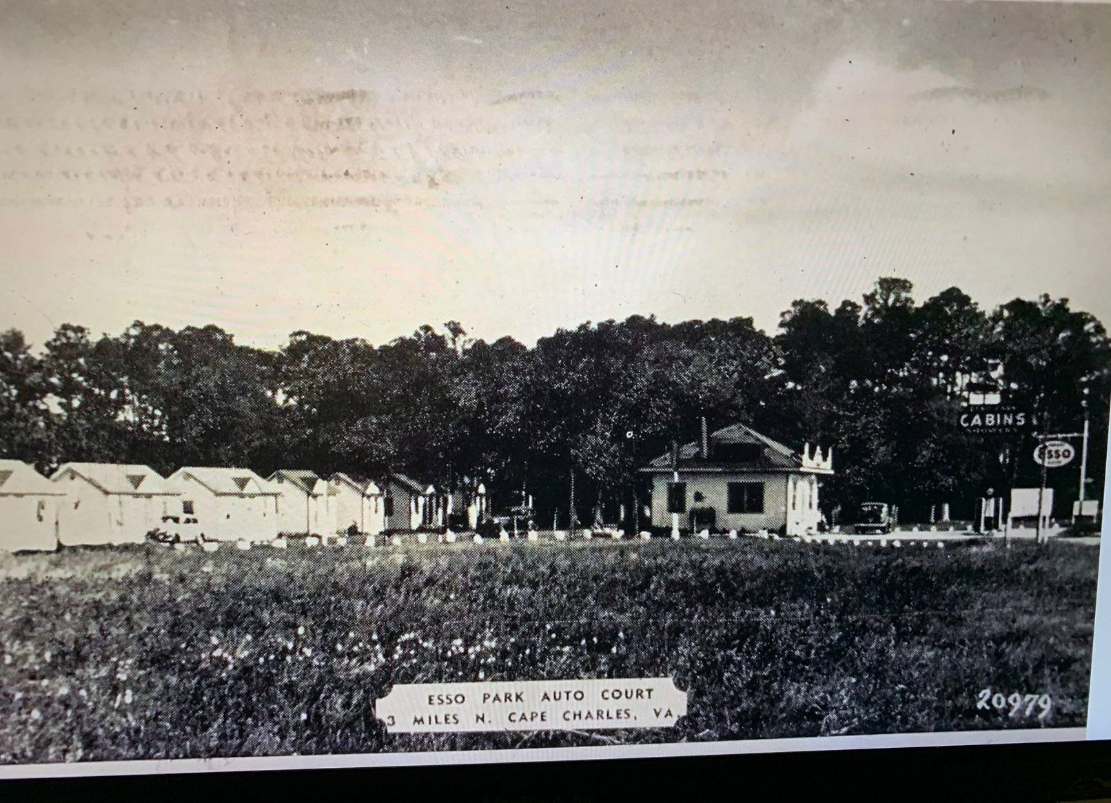 a black and white photo of a small house in a field