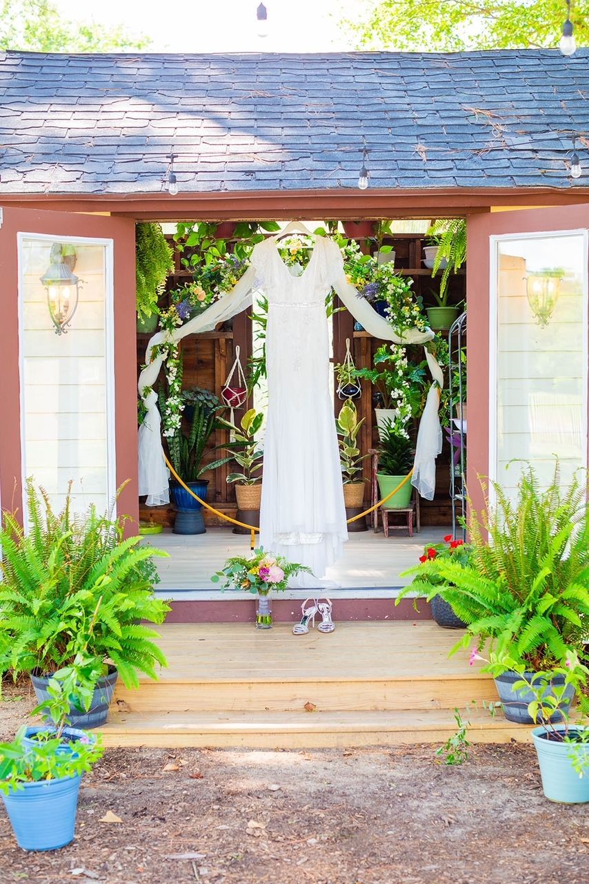 a wedding dress is hanging from the roof of a shed .