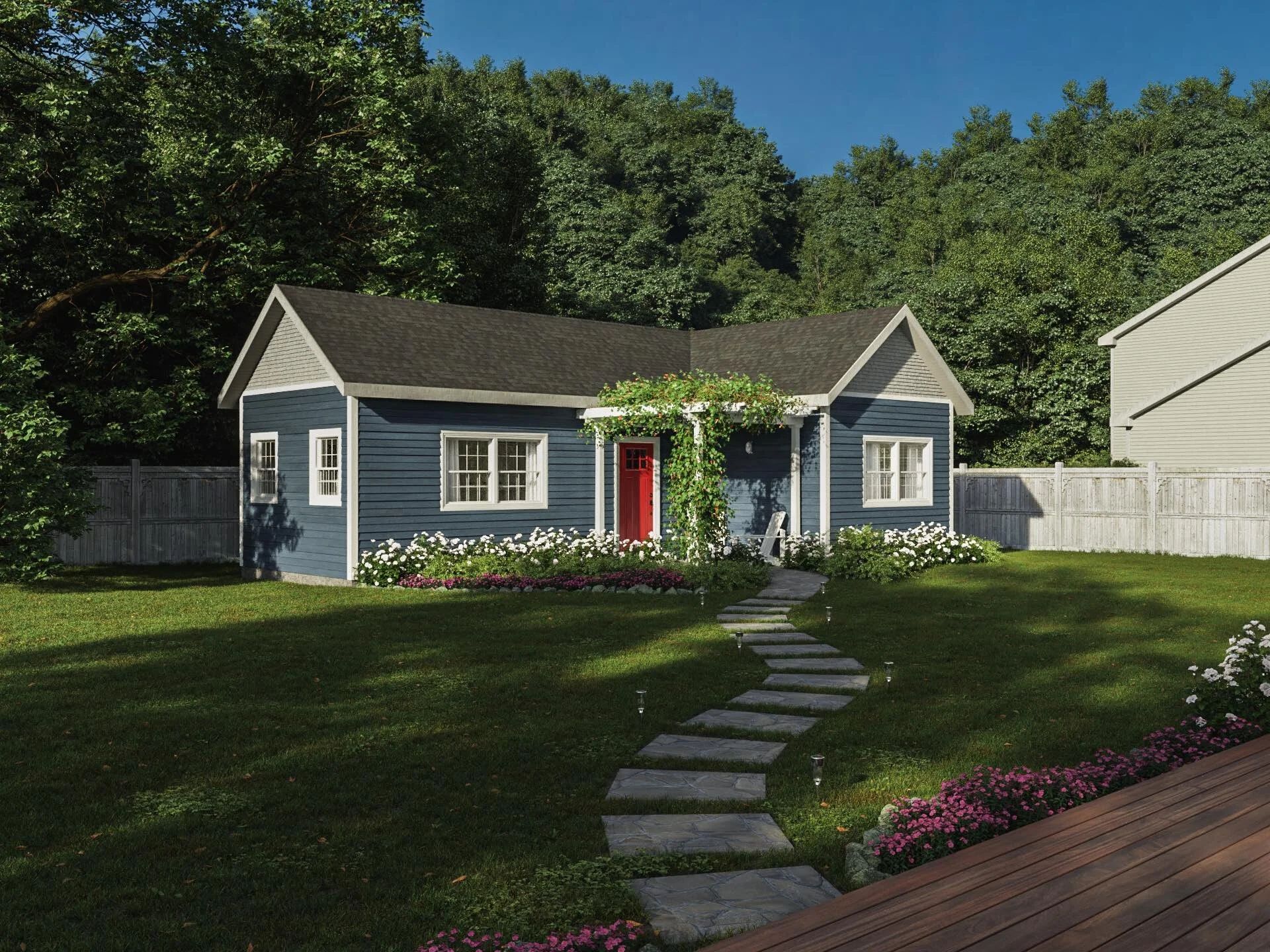 Tan shed with black roof in a backyard, brown wooden fence and green house visible, sunny day.