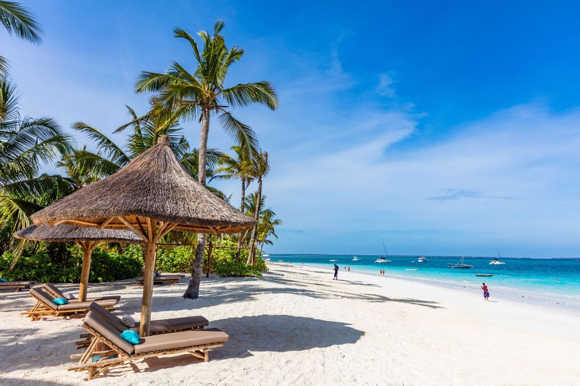 There are many chairs and umbrellas on the beach.