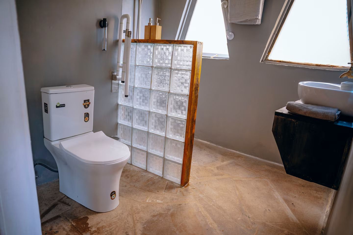 A bathroom with a sink , mirror and first aid kit.