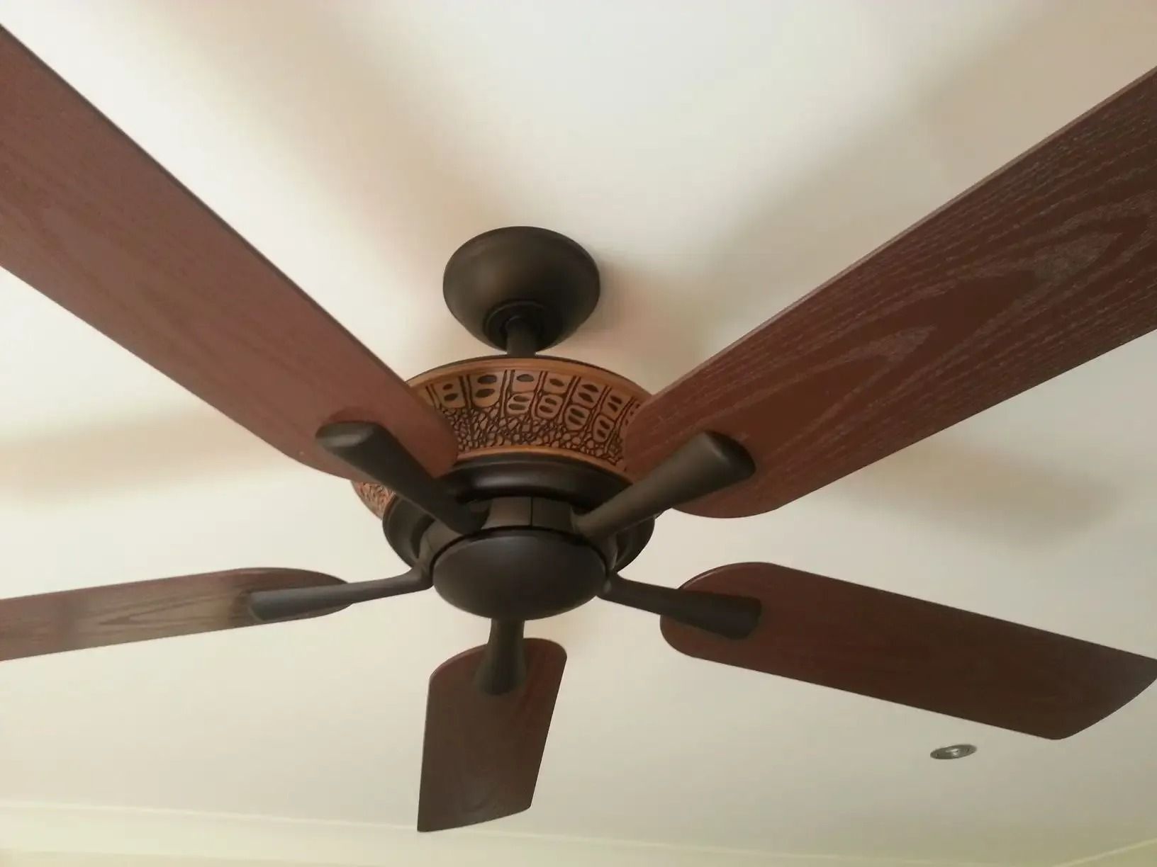 A Close up Of a Ceiling Fan with Wooden Blades — Jason Jeffrey Electrical in South Tamworth, NSW