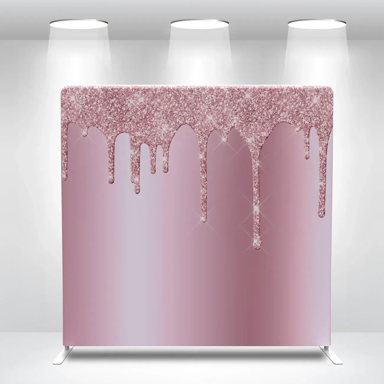 A pink backdrop with glitter dripping down it is sitting in a room.