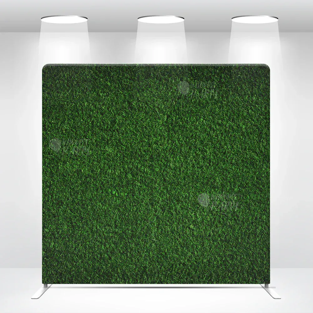 A green hedge wall is sitting in a room with three lights.