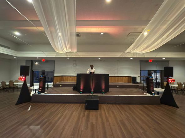 dj booth, stage, uplights, speakers for a sweet 16